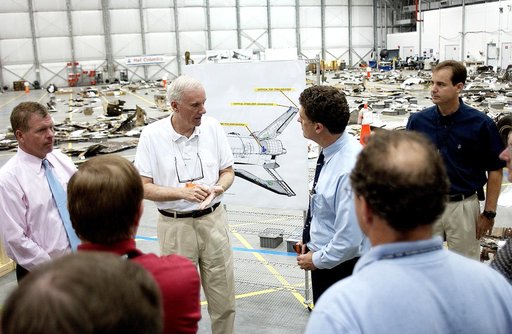 KENNEDY SPACE CENTER, FLA. - Adm. Harold Gehman, center, chairman of the Columbia Investigation Accident Board,  talks to U.S. Representative Dave Weldon (right) during the CAIB’s visit to the KSC RLV Hangar.  Left of Gehman is U.S. Representative Tom Feeney.  Gehman and the board visited the Hangar