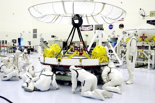 KENNEDY SPACE CENTER, FLA. - Workers in the Payload Hazardous Servicing Facility check the cruise stage of Mars Exploration Rover 1 (MER-1) that will be lifted and moved by the overhead crane for integration with the aeroshell, the entry vehicle.  NASA’s twin Mars Exploration Rovers are designed to 
