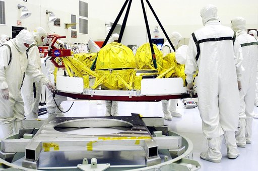 KENNEDY SPACE CENTER, FLA. - In the Payload Hazardous Servicing Facility, workers oversee the movement of the cruise stage of Mars Exploration Rover 1 (MER-1).  The cruise stage will be integrated with the aeroshell, the entry vehicle.   NASA’s twin Mars Exploration Rovers are designed to study the 
