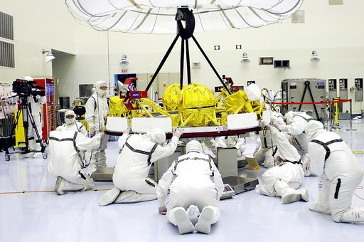 KENNEDY SPACE CENTER, FLA. - In the Payload Hazardous Servicing Facility, workers help guide the cruise stage of Mars Exploration Rover 1 (MER-1) as it is lowered onto blocks.  The cruise stage will be integrated with the aeroshell, the entry vehicle.   NASA’s twin Mars Exploration Rovers are design
