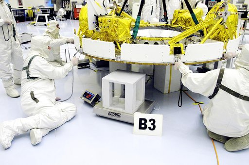 KENNEDY SPACE CENTER, FLA. - In the Payload Hazardous Servicing Facility, workers help guide the cruise stage of Mars Exploration Rover 1 (MER-1) as it is lowered onto blocks.  The cruise stage will be integrated with the aeroshell, the entry vehicle.   NASA’s twin Mars Exploration Rovers are design