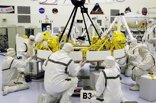KENNEDY SPACE CENTER, FLA. - In the Payload Hazardous Servicing Facility, workers check the status of the cruise stage of Mars Exploration Rover 1 (MER-1) after being lowered onto blocks.  The cruise stage will be integrated with the aeroshell, the entry vehicle.   NASA’s twin Mars Exploration Rover