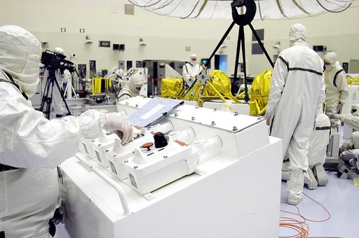 KENNEDY SPACE CENTER, FLA. - In the Payload Hazardous Servicing Facility, workers check the status of the cruise stage of Mars Exploration Rover 1 (MER-1) after being lowered onto blocks.  The cruise stage will be integrated with the aeroshell, the entry vehicle.   NASA’s twin Mars Exploration Rover