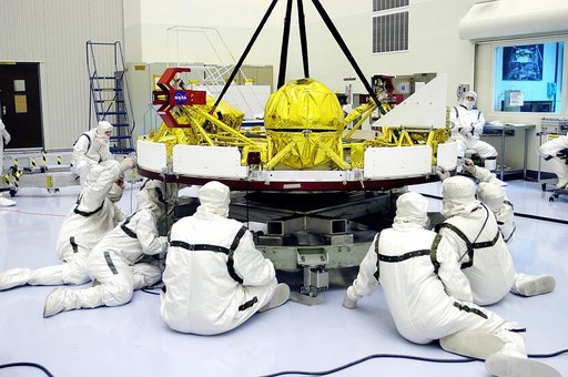 KENNEDY SPACE CENTER, FLA. - In the Payload Hazardous Servicing Facility, workers check the cruise stage of Mars Exploration Rover 1 (MER-1) being lifted off a stand.  The cruise stage will be integrated with the aeroshell, the entry vehicle.   NASA’s twin Mars Exploration Rovers are designed to stu