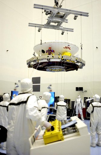 KENNEDY SPACE CENTER, FLA. - In the Payload Hazardous Servicing Facility, an overhead crane lifts the Mars Exploration Rover 2 (MER-2) to move it to a spin table.  NASA’s twin Mars Exploration Rovers are designed to study the history of water on Mars. These robotic geologists are equipped with a rob