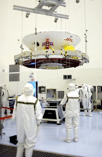 KENNEDY SPACE CENTER, FLA. - In the Payload Hazardous Servicing Facility, the Mars Exploration Rover 2 (MER-2) is moved to a spin table.  NASA’s twin Mars Exploration Rovers are designed to study the history of water on Mars. These robotic geologists are equipped with a robotic arm, a drilling tool,