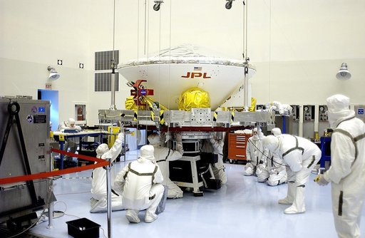 KENNEDY SPACE CENTER, FLA. - In the Payload Hazardous Servicing Facility, workers secure the Mars Exploration Rover 2 (MER-2) on the spin table.  NASA’s twin Mars Exploration Rovers are designed to study the history of water on Mars. These robotic geologists are equipped with a robotic arm, a drilli