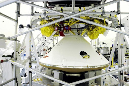 KENNEDY SPACE CENTER, FLA. - The Mars Exploration Rover 1 (MER-1) lander  (below) is mated to the cruise stage, seen above the lander.  NASA's twin Mars Exploration Rovers are designed to study the history of water on Mars. These robotic geologists are equipped with a robotic arm, a drilling tool, t