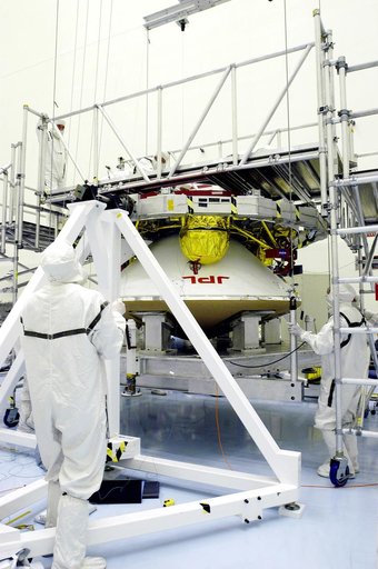 KENNEDY SPACE CENTER, FLA. - Workers in the Payload Hazardous Servicing Facility check the mating of the Mars Exploration Rover 1 (MER-1) cruise stage to the lander below it.  NASA's twin Mars Exploration Rovers are designed to study the history of water on Mars. These robotic geologists are equippe