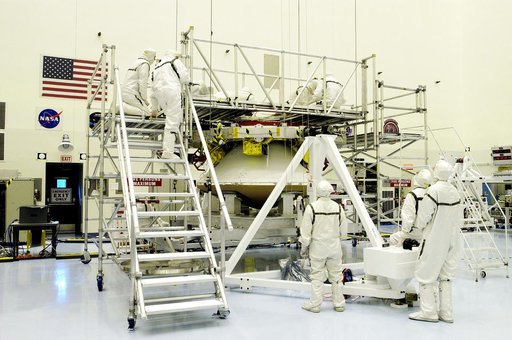 KENNEDY SPACE CENTER, FLA. - Workers in the Payload Hazardous Servicing Facility check the mating of the Mars Exploration Rover 1 (MER-1) cruise stage to the lander below it.  NASA's twin Mars Exploration Rovers are designed to study the history of water on Mars. These robotic geologists are equippe