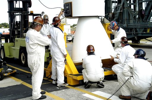 KENNEDY SPACE CENTER, FLA. - On Launch Complex 17-B, Cape Canaveral Air Force Station,  workers make adjustments on the solid rocket booster after its lift to vertical.  It is one of nine SRBs that will be mated to the Delta II rocket for the Mars Exploration Rover 1 (MER-1) launch June 25.  NASA’s 