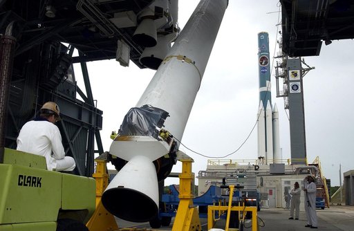 KENNEDY SPACE CENTER, FLA. -  On Launch Complex 17-B, Cape Canaveral Air Force Station, a solid rocket booster is lifted to vertical.  It will be mated to the Delta II rocket (in the background) for the Mars Exploration Rover 1 (MER-1) launch June 25.  NASA’s twin Mars Exploration Rovers are designe