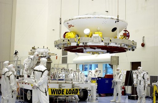 KENNEDY SPACE CENTER, FLA. -  In the Payload Hazardous Servicing Facility, workers prepare to mate the Mars Exploration Rover-2 (MER-2) to the third stage of a Delta II rocket for launch on June 5.  NASA’s twin Mars Exploration Rovers are designed to study the history of water on Mars. These robotic