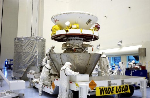 KENNEDY SPACE CENTER, FLA. - Workers in the Payload Hazardous Servicing Facility secure the lower sections of the transport canister around the Mars Exploration Rover 2 (MER-2).  The upper portion waits at left.  After encapsulation, MER-2 will be transferred to Launch Complex 17-A, Cape Canaveral A