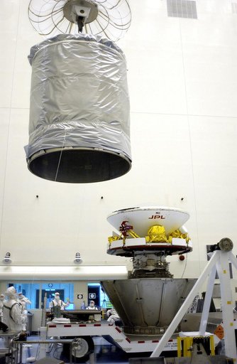 KENNEDY SPACE CENTER, FLA. - In the Payload Hazardous Servicing Facility, an overhead crane moves the canister that will complete encapsulation of the Mars Exploration Rover 2 (MER-2), at right.  After encapsulation, MER-2 will be transferred to Launch Complex 17-A, Cape Canaveral Air Force Station.