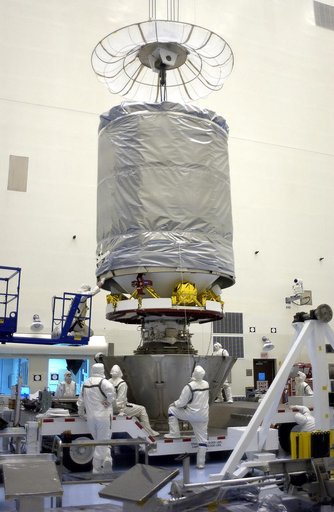 KENNEDY SPACE CENTER, FLA. - In the Payload Hazardous Servicing Facility, workers attach the upper canister to the lower portion to encapsulate the Mars Exploration Rover 2 (MER-2).  After encapsulation, MER-2 will be transferred to Launch Complex 17-A, Cape Canaveral Air Force Station.  MER-2 is on