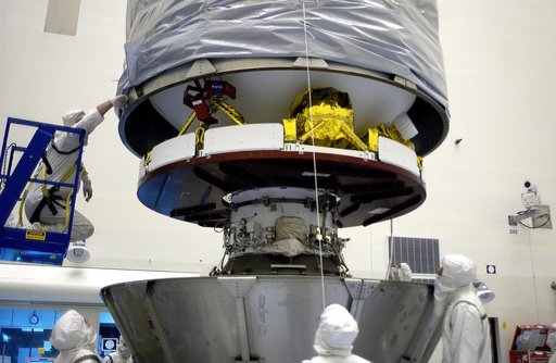 KENNEDY SPACE CENTER, FLA. - In the Payload Hazardous Servicing Facility, an overhead crane lowers the canister that will complete encapsulation of the Mars Exploration Rover 2 (MER-2), at right.  After encapsulation, MER-2 will be transferred to Launch Complex 17-A, Cape Canaveral Air Force Station