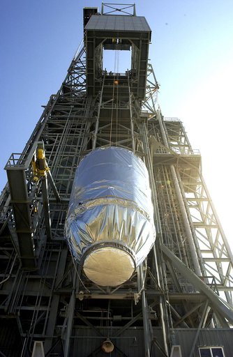 KENNEDY SPACE CENTER, FLA. - On Launch Pad 17-A, Cape Canaveral Air Force Station, the Mars Exploration Rover 2 (MER-2), inside the transport canister, is lifted up the launch tower where it will be mated to the Delta II rocket for launch.  MER-2 is one of NASA's twin Mars Exploration Rovers designe