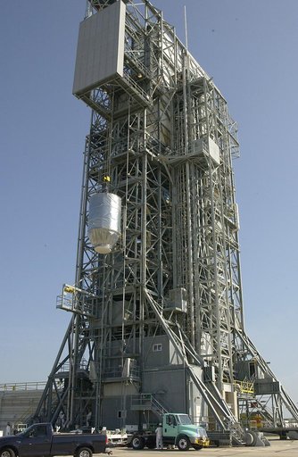 KENNEDY SPACE CENTER, FLA. - On Launch Pad 17-A, Cape Canaveral Air Force Station, the Mars Exploration Rover 2 (MER-2), inside the transport canister, is lifted up the launch tower where it will be mated to the Delta II rocket for launch.  MER-2 is one of NASA's twin Mars Exploration Rovers designe