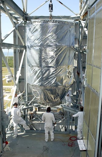 KENNEDY SPACE CENTER, FLA. - On Launch Pad 17-A, Cape Canaveral Air Force Station, the Mars Exploration Rover 2 (MER-2), inside the transport canister, is moved toward the platform in the launch tower.  MER-2 will be mated to the Delta II rocket for launch.  MER-2 is one of NASA's twin Mars Explorat