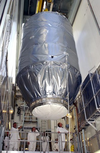 KENNEDY SPACE CENTER, FLA. - On Launch Pad 17-A, Cape Canaveral Air Force Station, the Mars Exploration Rover 2 (MER-2), is maneuvered above the Delta II rocket in the launch tower.  It will be mated to the rocket for launch.  MER-2 is one of NASA's twin Mars Exploration Rovers designed to study the