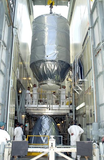 KENNEDY SPACE CENTER, FLA. - On Launch Pad 17-A, Cape Canaveral Air Force Station, the Mars Exploration Rover 2 (MER-2), inside the transport canister, is lowered toward the Delta II rocket for mating.  MER-2 is one of NASA's twin Mars Exploration Rovers designed to study the history of water on Mar