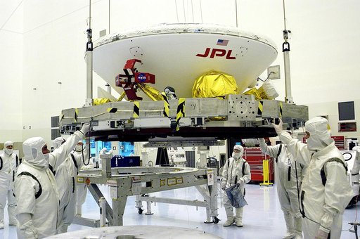 KENNEDY SPACE CENTER, FLA. - In the Payload Hazardous Servicing Facility, workers attach a crane to the Mars Exploration Rover-1 (MER-B) as they prepare to lift it onto a spin table during preflight processing of the spacecraft.  The rover is scheduled to launch aboard a Delta II rocket on June 25. 