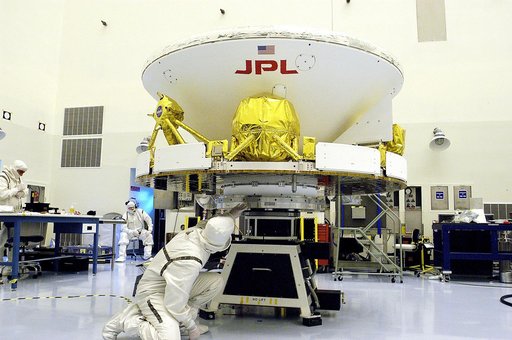 KENNEDY SPACE CENTER, FLA. - In the Payload Hazardous Servicing Facility, workers secure the Mars Exploration Rover-1 (MER-B) to a spin table during preflight processing of the spacecraft. The rover is scheduled to launch aboard a Delta II rocket on June 25. NASA’s twin Mars Exploration Rovers are d