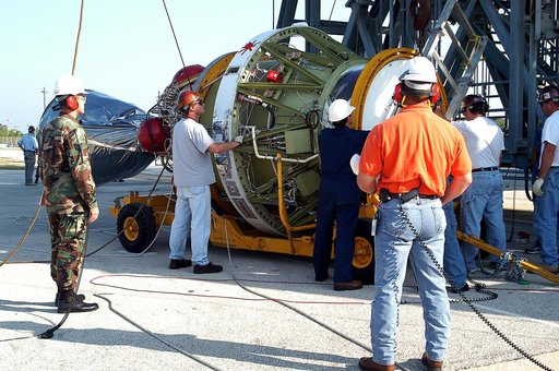 KENNEDY SPACE CENTER, FLA. - Workers prepare to lift the second stage of a Delta II rocket up the launch tower on Pad 17-B, Cape Canaveral Air Force Station.  It will be mated to the Delta first stage already at the pad in preparation for the launch of the Mars Exploration Rover-1 (MER-B) on June 25