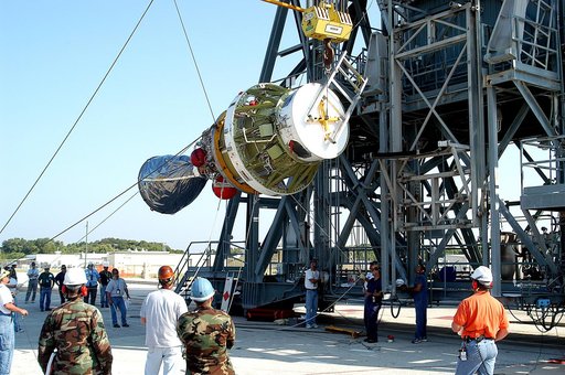 KENNEDY SPACE CENTER, FLA. - Workers begin to lift the second stage of a Delta II rocket up the launch tower on Pad 17-B, Cape Canaveral Air Force Station.  It will be mated to the Delta first stage already at the pad in preparation for the launch of the Mars Exploration Rover-1 (MER-B) on June 25. 