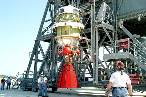 KENNEDY SPACE CENTER, FLA. - The second stage of a Delta II rocket is raised to a vertical position and prepared for its lift up the launch tower on Pad 17-B, Cape Canaveral Air Force Station.  It will be mated to the Delta first stage already at the pad in preparation for the launch of the Mars Exp