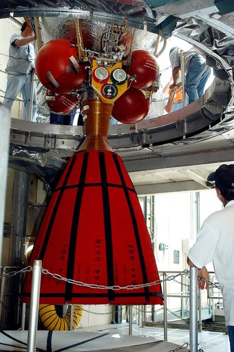 KENNEDY SPACE CENTER, FLA. - The second stage of a Delta II rocket is lowered into positioned above a first stage at Pad 17-B, Cape Canaveral Air Force Station. Next, it will be mated to the first stage in preparation for the launch of the Mars Exploration Rover-1 (MER-B) on June 25.  NASA’s twin Ma