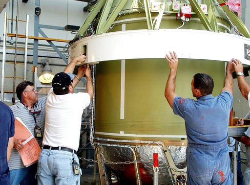 KENNEDY SPACE CENTER, FLA. - The second stage of a Delta II rocket is lowered into positioned above a first stage at Pad 17-B, Cape Canaveral Air Force Station. Next, it will be mated to the first stage in preparation for the launch of the Mars Exploration Rover-1 (MER-B) on June 25.  NASA’s twin Ma