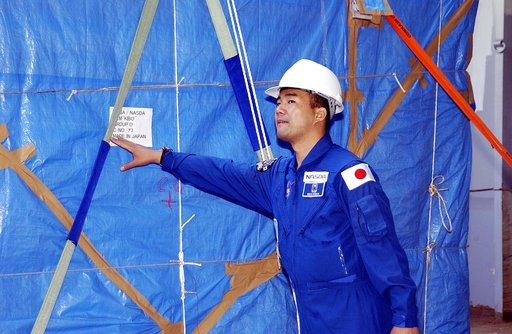 KENNEDY SPACE CENTER, FLA. - Astronaut Soichi Noguchi, with the National Space Development Agency of Japan (NASDA), looks at the Japanese Experiment Module after its arrival at Port Canaveral, Fla.   Built by the Tsukuba Space Center near Tokyo, the pressurized module is the first element of the JEM