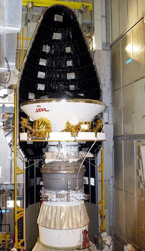 KENNEDY SPACE CENTER, FLA. - At Launch Complex 17-A, Cape Canaveral Air Force Station, the first half of the fairing for the Mars Exploration Rover 2 (MER-2) is seen behind the spacecraft.  MER-2 is one of NASA's twin Mars Exploration Rovers designed to study the history of water on Mars. These robo