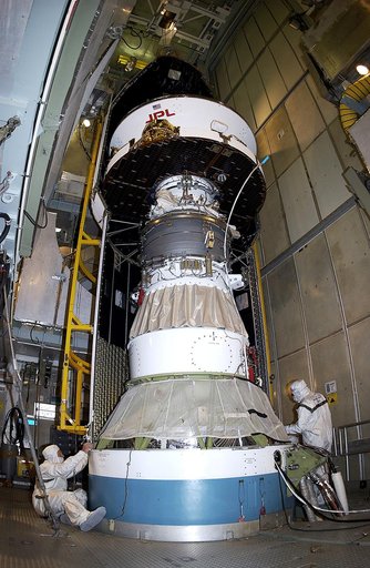 KENNEDY SPACE CENTER, FLA. - At Launch Complex 17-A, Cape Canaveral Air Force Station, the first half of the fairing for the Mars Exploration Rover 2 (MER-2) is installed around the Mars Exploration Rover 2 (MER-2).  MER-2 is one of NASA's twin Mars Exploration Rovers designed to study the history o
