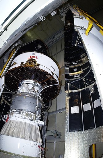 KENNEDY SPACE CENTER, FLA. - The second half of the fairing is moved toward the Mars Exploration Rover 2 (MER-2) on Launch Complex 17-A, Cape Canaveral Air Force Station.  MER-2 is one of NASA's twin Mars Exploration Rovers designed to study the history of water on Mars. These robotic geologists are