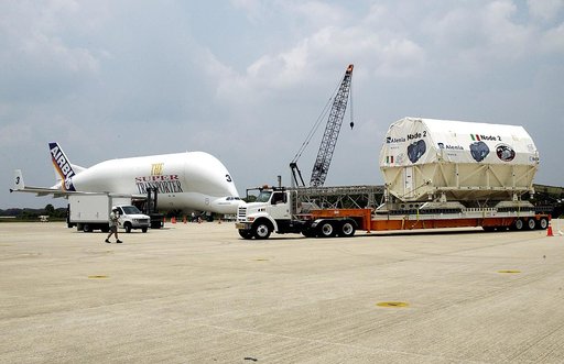 KENNEDY SPACE CENTER, FLA. -  The Italian-built module, U.S. Node 2, begins its transfer from  the Shuttle Landing Facility to the Space Station Processing Facility.  Inthe background, left, is the Beluga aircraft that brought it to KSC.  The second of three connecting modules on the International S