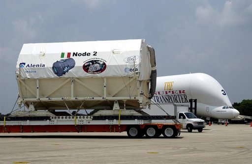 KENNEDY SPACE CENTER, FLA. -  The Italian-built module, U.S. Node 2, moves past the Beluga aircraft that brought it to KSC as it is transferred to the Space Station Processing Facility. The second of three connecting modules on the International Space Station, Node 2 attaches to the end of the U.S. 