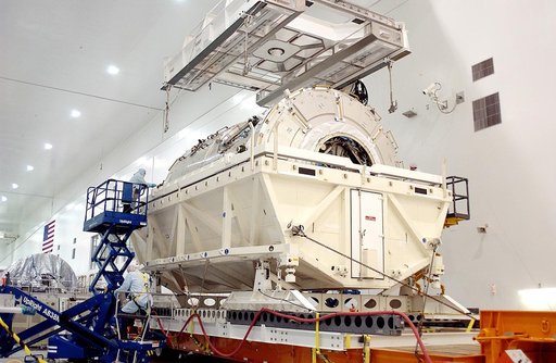 KENNEDY SPACE CENTER, FLA. - An overhead crane in the Space Station Processing Facility is attached to the U.S. Node 2 to lift it out of its shipping container.  The node will be moved to a workstand.  The second of three connecting modules on the International Space Station, the Italian-built Node 