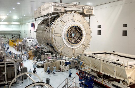 KENNEDY SPACE CENTER, FLA. - An overhead crane in the Space Station Processing Facility carries the U.S. Node 2 across the floor to a workstand.  The second of three connecting modules on the International Space Station, the Italian-built Node 2 attaches to the end of the U.S. Lab and provides attac