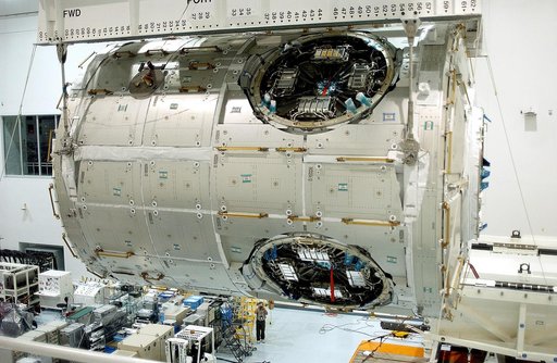 KENNEDY SPACE CENTER, FLA. - An overhead crane in the Space Station Processing Facility moves the U.S. Node 2 across the floor to a workstand.  The second of three connecting modules on the International Space Station, the Italian-built Node 2 attaches to the end of the U.S. Lab and provides attach 
