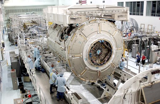 KENNEDY SPACE CENTER, FLA. - The U.S. Node 2 is lowered toward a workstand in the Space Station Processing Facility.  The second of three connecting modules on the International Space Station, the Italian-built Node 2 attaches to the end of the U.S. Lab and provides attach locations for the Japanese