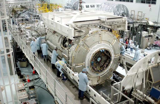 KENNEDY SPACE CENTER, FLA. -  The U.S. Node 2 is lowered onto a workstand in the Space Station Processing Facility.  The second of three connecting modules on the International Space Station, the Italian-built Node 2 attaches to the end of the U.S. Lab and provides attach locations for the Japanese 
