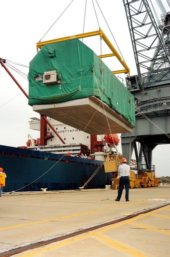 KENNEDY SPACE CENTER, FLA. - At Port Canaveral, the Pressurized Module of the Japanese Experiment Module (JEM) is suspended over the dock, waiting for a truck that will transfer it to KSC’s Space Station Processing Facility. The container transport ship carrying JEM departed May 2 from Yokohama Harb