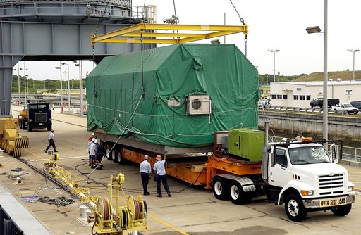 KENNEDY SPACE CENTER, FLA. - At Port Canaveral, the Pressurized Module of the Japanese Experiment Module (JEM) is settled on a truck bed for transfer to KSC’s Space Station Processing Facility.  The container transport ship carrying JEM departed May 2 from Yokohama Harbor in Japan for the voyage to 