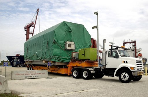 KENNEDY SPACE CENTER, FLA. -  The transporter rolls out of Port Canaveral with the Pressurized Module of the Japanese Experiment Module (JEM) aboard.  The National Space Development Agency of Japan (NASDA) developed the laboratory at the Tsukuba Space Center near Tokyo. The Pressurized Module is the