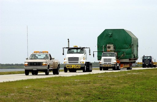 KENNEDY SPACE CENTER, FLA. -  A convoy accompanies the truck transporting the Pressurized Module of the Japanese Experiment Module (JEM) to KSC’s Space Station Processing Facility.  The National Space Development Agency of Japan (NASDA) developed the laboratory at the Tsukuba Space Center near Tokyo