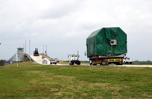 KENNEDY SPACE CENTER, FLA. - A convoy accompanies the truck transporting the Pressurized Module of the Japanese Experiment Module (JEM) to KSC’s Space Station Processing Facility.  The National Space Development Agency of Japan (NASDA) developed the laboratory at the Tsukuba Space Center near Tokyo.