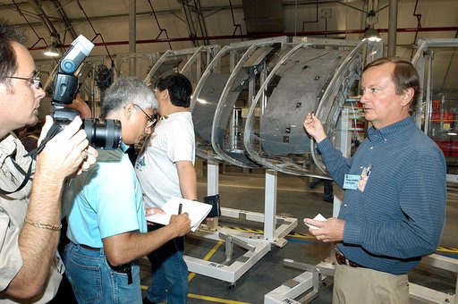 KENNEDY SPACE CENTER, FLA. - In the Columbia Debris Hangar,  Shuttle Launch Director Mike Leinbach  (right) talks to the media about activities that have taken place since the Columbia accident on Feb. 1, 2003.  STS-107 debris recovery and reconstruction operations are winding down.  To date, nearly
